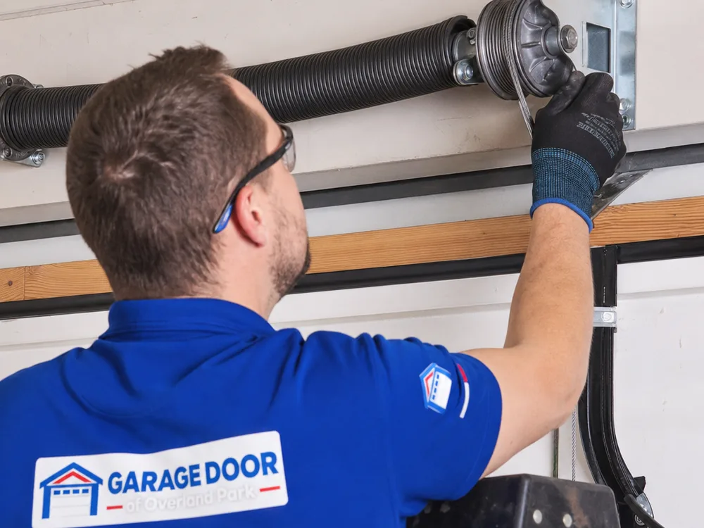 Garage door torsion spring and cable drum with cable seated in the grooves
