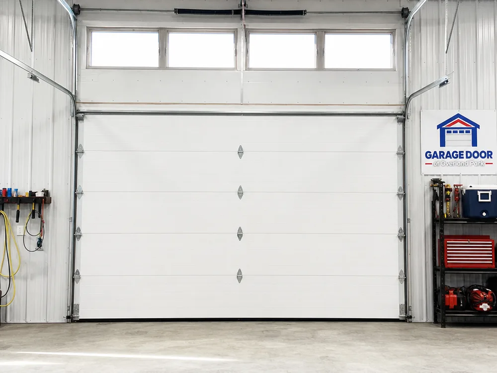 Installed insulated sectional steel overhead door with high-lift track in a light industrial building