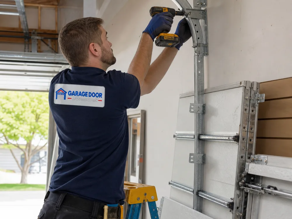Contractor leveling and fastening garage door track hardware inside a residential garage with door sections ready for assembly